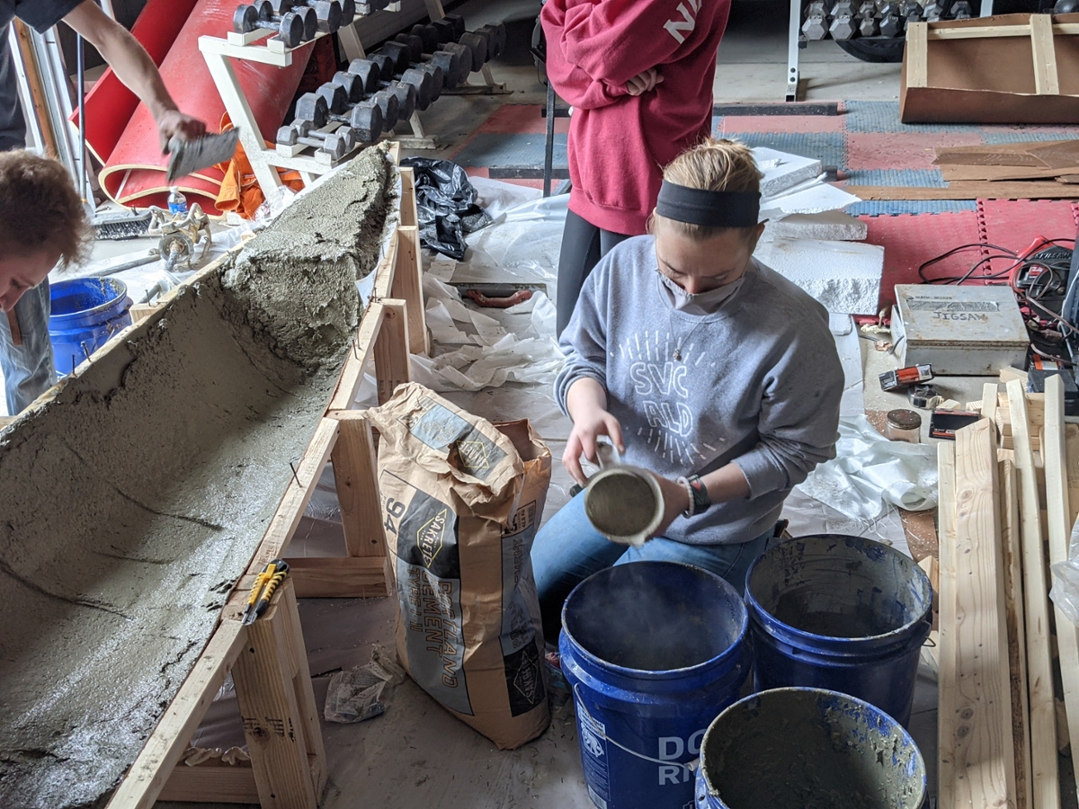 Student mixing concrete